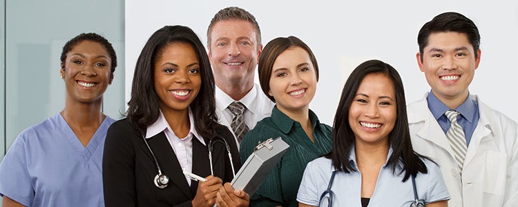 Group of doctors and nurses smiling.