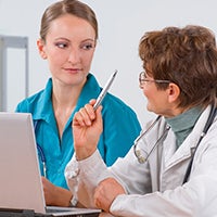 Doctor and nurse talking to each other.