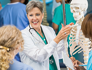 Doctor showing skeleton anatomy to patient.